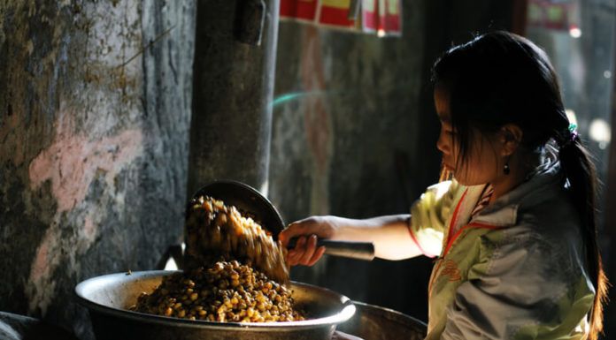 A girl is cooking Mau Son Rice Wine - Vietnamese Wines - Vietnam Immigration Services 